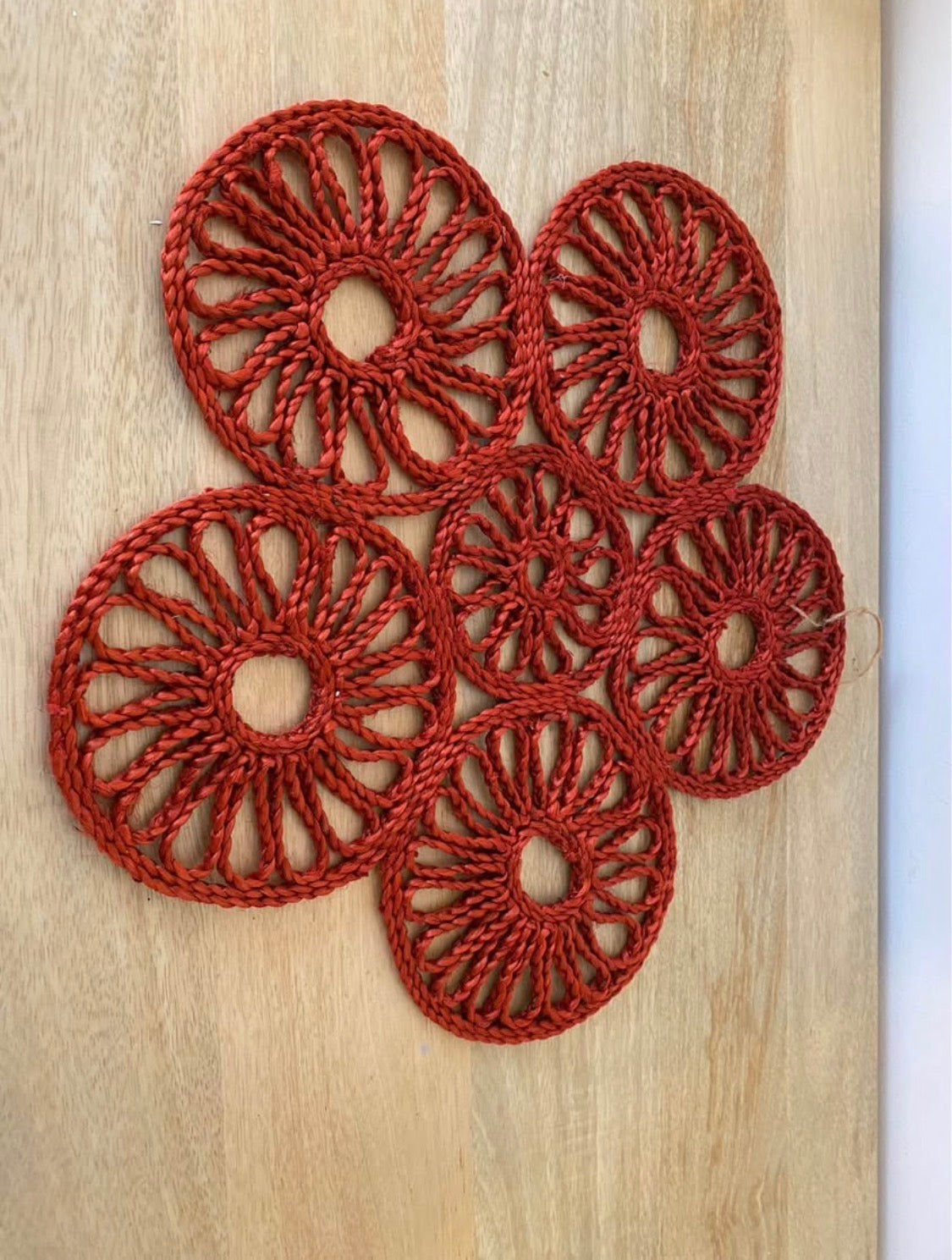 Handmade natural jute centre mat in burnt red colour - 40 cm diameter